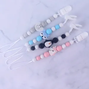 Detail of four colorful silicone pacifier clips with elephant and unicorn animal shapes