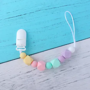 Detail of macaron silicone beads and plastic clip for baby pacifier chain