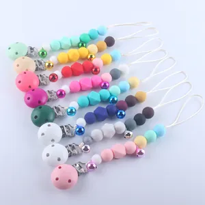 Colorful silicone baby pacifier clip with wooden beads and bell on white background