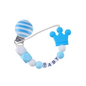 Close-up of baby pacifier clip with blue crown bead and BABY letter square beads