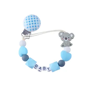 Detail of baby silicone pacifier clip with blue koala beads and BABY letter squares