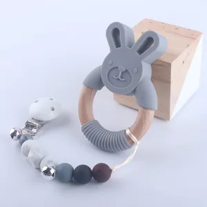 Detail view of silicone baby teether with rabbit wood ring and beaded pacifier clip