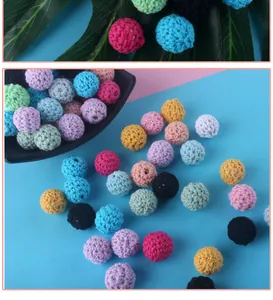 Macro detail of 16mm crochet yarn-covered beads in assorted macaron colors for DIY jewelry