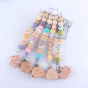 Detail of assorted silicone pacifier clips with natural wood beads and crochet details