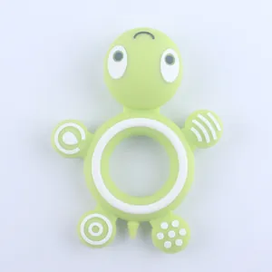 Green turtle silicone baby teether with textured massaging surfaces for teething relief