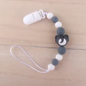 Macro detail of silicone pacifier clip featuring grey elephant bead and white beads