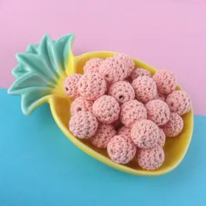 Macro view of 16mm pink crochet cotton beads with weave texture for DIY jewelry making