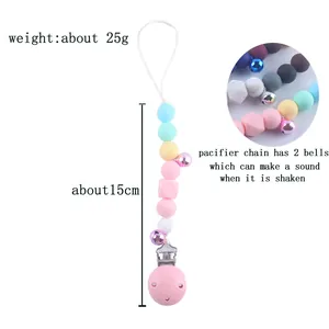 Silicone baby pacifier clip with macaron beads and small bells on white background