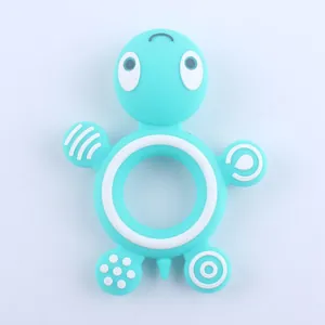 Macro view of blue silicone turtle teether with various massage textures for baby gum relief