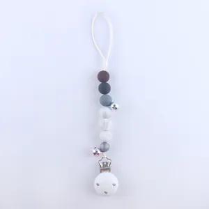 Detail of silicone pacifier clip with grey beads, metal bells and sturdy buckle
