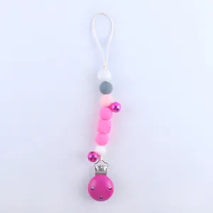 Detail of pink and grey silicone bead pacifier clip with metal clamp and bells