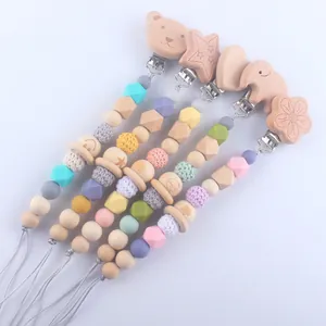 Handmade silicone and wood baby pacifier clips with cute animal shapes and crochet beads