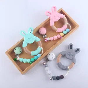 Silicone rabbit teether with wooden rings and beaded pacifier clips in three colors