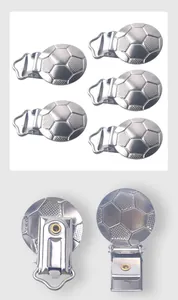 Macro detail of football embossed silver metal pacifier clips with sturdy iron round base