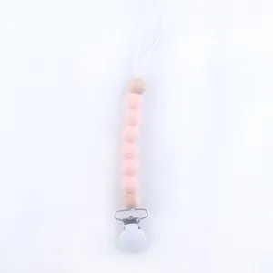 Detailed view of silicone beads and wooden ball on baby pacifier clip chain