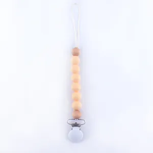 Detail view of baby pacifier clip with natural wood beads and soft silicone beads