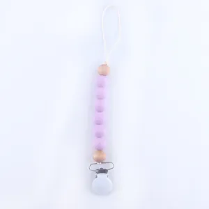 Close-up of baby pacifier clip with lavender silicone beads and natural wooden beads