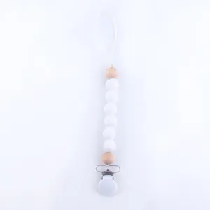 Detail of silicone and wood beads pacifier clip with secure metal fastener for baby