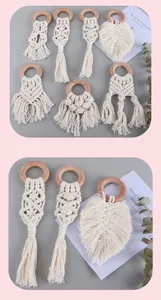 Detailed macro shot of handmade bohemian beech wood teething ring with woven cotton leaf tassel