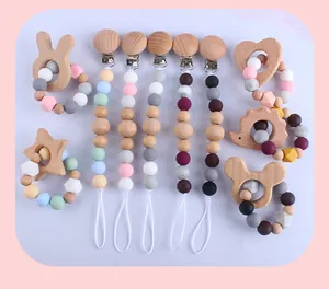 Detail of beech wood teething rings and silicone bead pacifier clips for babies