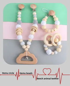 Detail of wooden baby teether with rattle bell and colorful crochet silicone bead clips