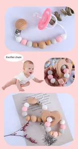 Detail of baby pacifier chain with pink and grey silicone beads and beech wood heart charm