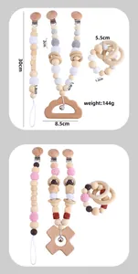 Detailed view of handmade baby pacifier clip and wooden teether with crochet beads