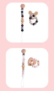 Detail of wooden bear and heart teethers with silicone pacifier clips in soft colors