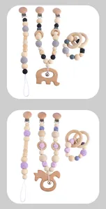 Detail of wooden baby pacifier clips and crochet teether toys with elephant charms