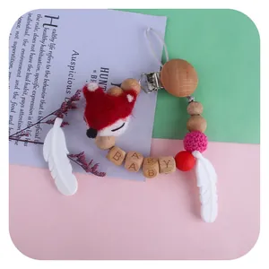 Silicone and wooden baby pacifier chain with fox doll and white feather pendant