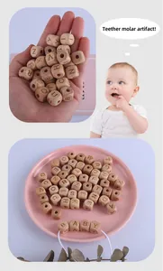 Macro shot of natural beech wood alphabet beads for DIY baby pacifier chains and teethers