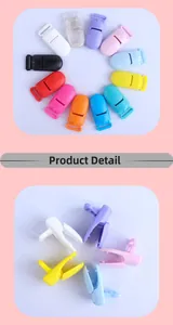 Macro view of colorful plastic pacifier clips showing open and closed mechanism
