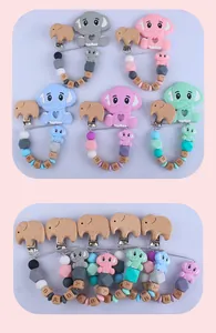 Close-up of elephant teething clips in multiple colors with wooden BABY letter beads