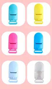 Close-up of colorful plastic baby pacifier clips in various shades for DIY accessory making