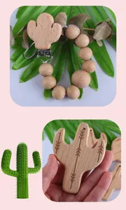 Close-up of baby wooden teething pendant with cactus charm and natural beech wood beads