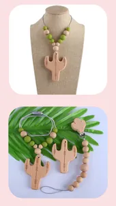 Detail of beech wood cactus teether and silicone pacifier clip on linen background