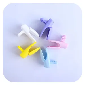 Colorful macaron plastic pacifier clips for baby DIY accessories arranged in a circle
