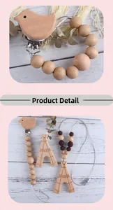 Detail of wooden baby teether set with bird clip and beech wood triangle pendant