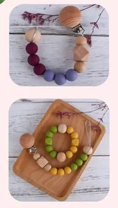 Detail view of silicone and beech wood baby pacifier clip with secure stainless steel clamp