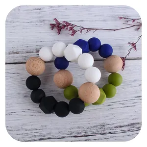 Silicone and beech wood baby teething bracelets in blue and green color combinations