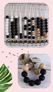Detail view of beech wood and silicone bead pacifier clips with durable metal fasteners