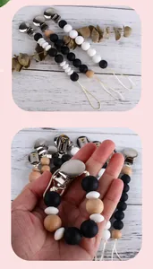 Detail of wooden and silicone pacifier clip with round metal clasp for babies