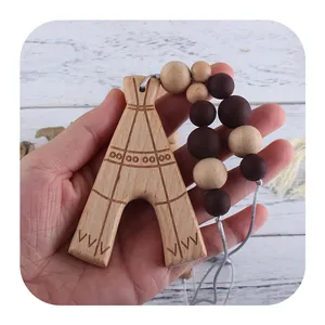 Beechwood baby teether toy with tent pendant and colorful beads on white wood background