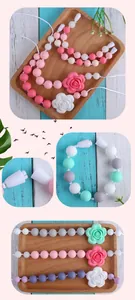 Detail of macaron color silicone beads with rose flower pendant and safety break-away clasp