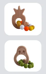 Detail of wooden avocado and pineapple baby teethers with colorful silicone beads