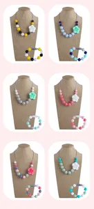 Detail of colorful rose silicone teething necklace and matching bracelet set for infants