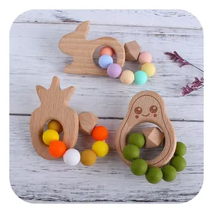 DIY beech wood and silicone baby teething rings with cute animal shapes on white wood