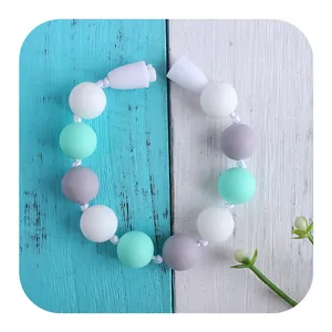 Silicone rose baby teether necklace with mint green, white, and grey beads for soothing