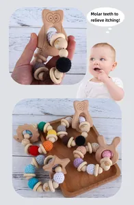 Detail of wooden baby teether rattle set with crochet beads and animal shape molar rings