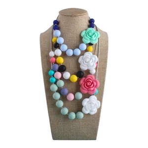 Silicone rose flower teething necklace with colorful beads for babies on display stand